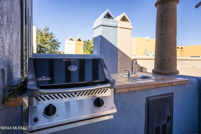 view of patio / terrace featuring area for grilling and sink