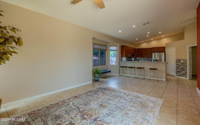 kitchen featuring light tile patterned flooring, kitchen peninsula, and stainless steel appliances