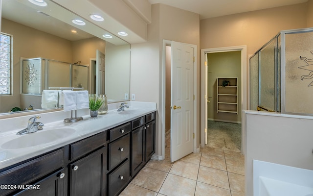 bathroom with shower with separate bathtub, vanity, and tile patterned floors