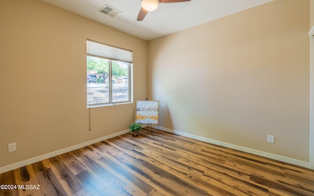 empty room featuring hardwood / wood-style flooring and ceiling fan