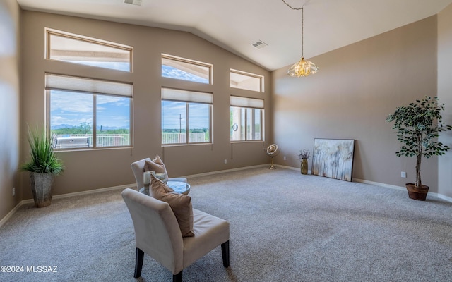 sitting room featuring carpet flooring, a notable chandelier, and vaulted ceiling