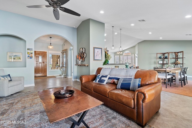 living area featuring visible vents, arched walkways, baseboards, vaulted ceiling, and recessed lighting