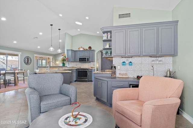 interior space featuring gray cabinetry, a peninsula, visible vents, appliances with stainless steel finishes, and open shelves