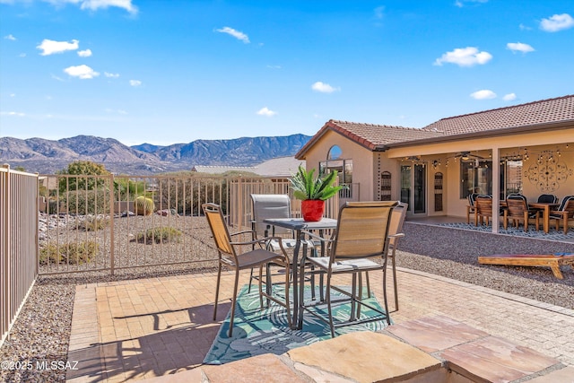 view of patio featuring ceiling fan and a mountain view