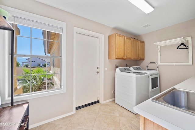 laundry room with cabinet space, baseboards, visible vents, washer and dryer, and light tile patterned flooring