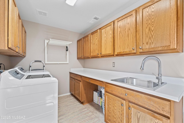 laundry room with cabinet space, visible vents, a sink, and independent washer and dryer