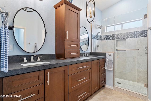 bathroom with tile patterned flooring, a sink, a shower stall, and double vanity