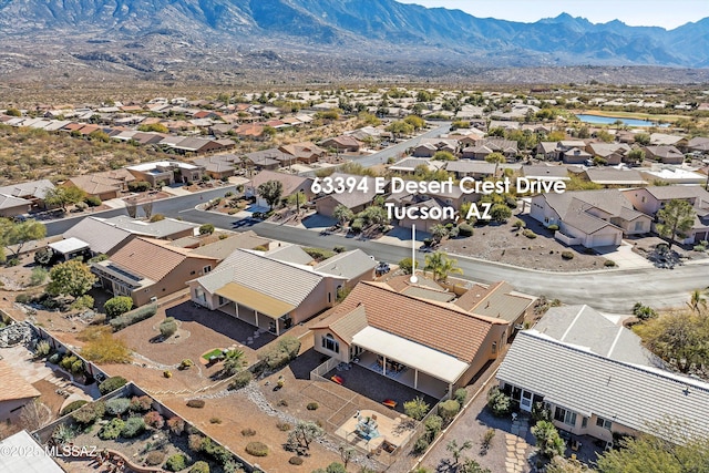 birds eye view of property with a residential view and a mountain view