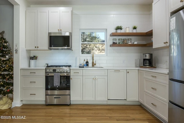 kitchen featuring sink, white cabinets, and stainless steel appliances