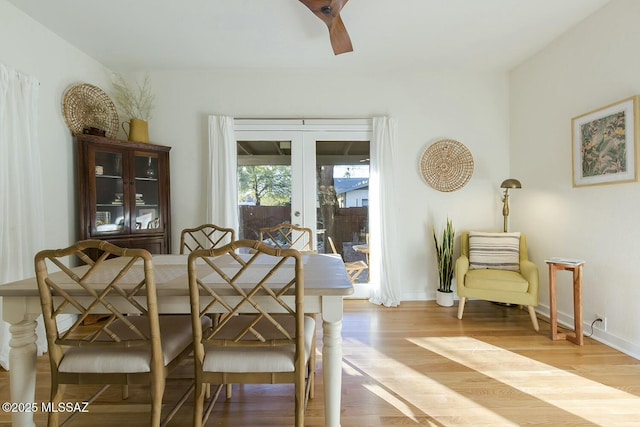 dining space with ceiling fan, french doors, and light hardwood / wood-style floors