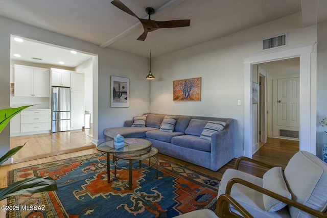 living room with dark hardwood / wood-style floors and ceiling fan