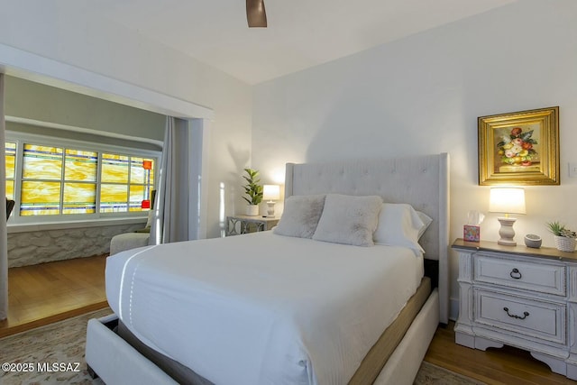 bedroom featuring ceiling fan and dark wood-type flooring