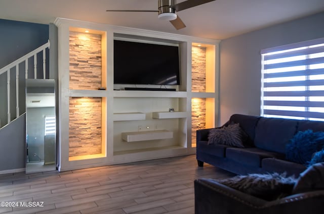 living room featuring ceiling fan, built in features, and hardwood / wood-style floors