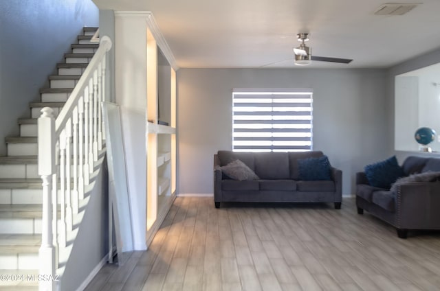 living room with light wood-type flooring and ceiling fan