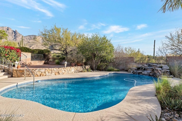 view of pool with a mountain view and a patio