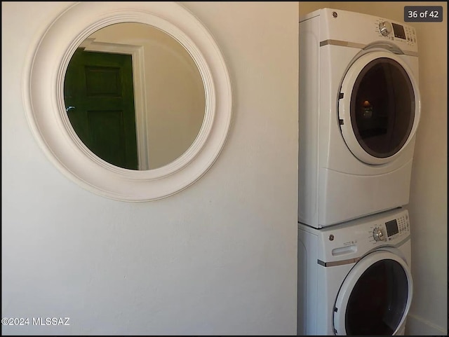 laundry room featuring stacked washer / drying machine