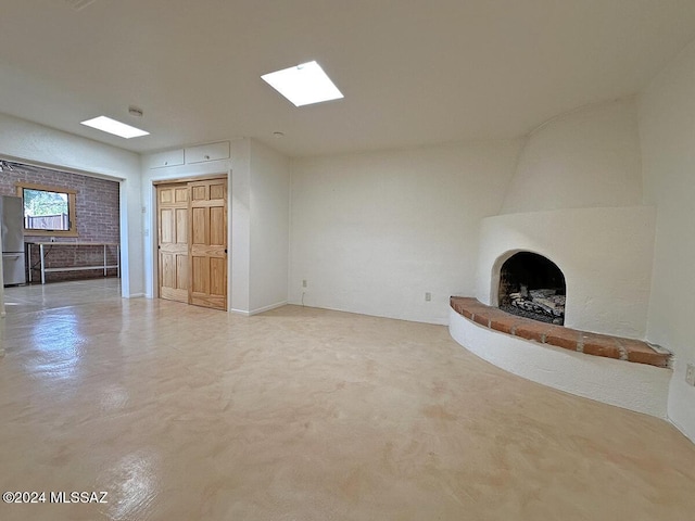 unfurnished living room featuring a large fireplace