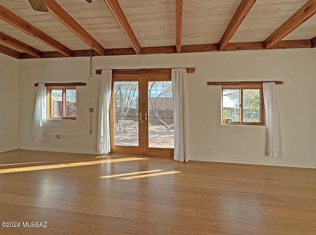 interior space with a healthy amount of sunlight, light wood-type flooring, wood ceiling, and french doors