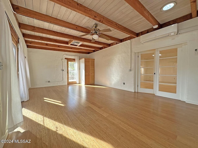 interior space with ceiling fan, a wall mounted AC, beamed ceiling, light hardwood / wood-style floors, and wood ceiling