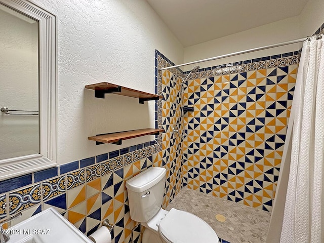 bathroom featuring a shower with curtain, toilet, and tile walls