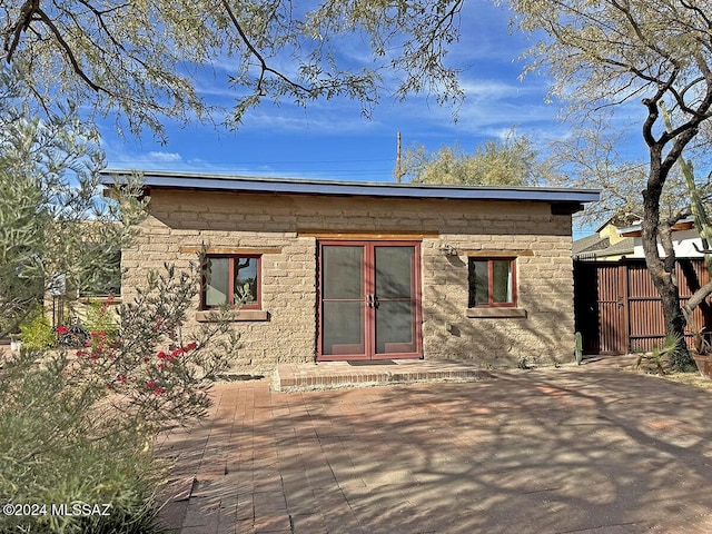 back of property with a patio area and french doors