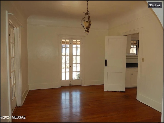 empty room featuring dark hardwood / wood-style flooring and french doors