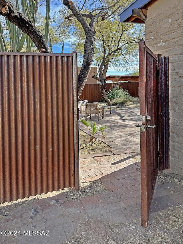 view of gate with a patio area