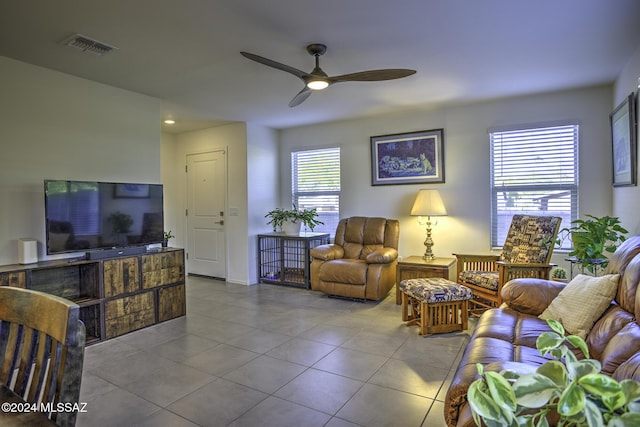 living room featuring light tile patterned floors, plenty of natural light, and ceiling fan