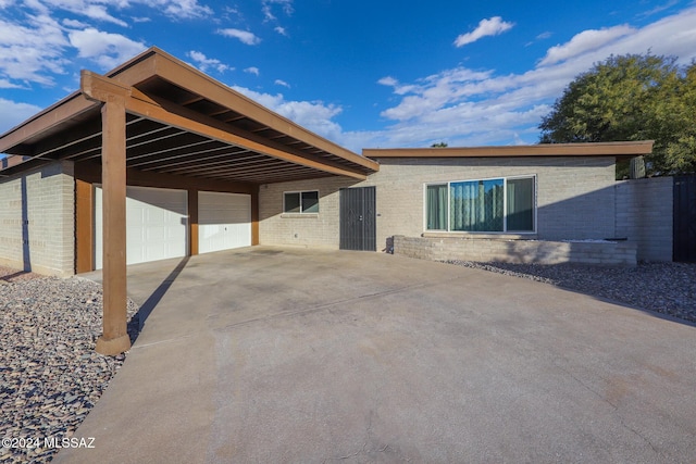 view of front of property with a garage and a carport