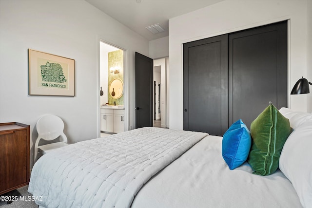 bedroom featuring ensuite bathroom and a closet