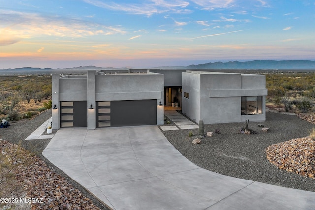 contemporary house with a mountain view and a garage