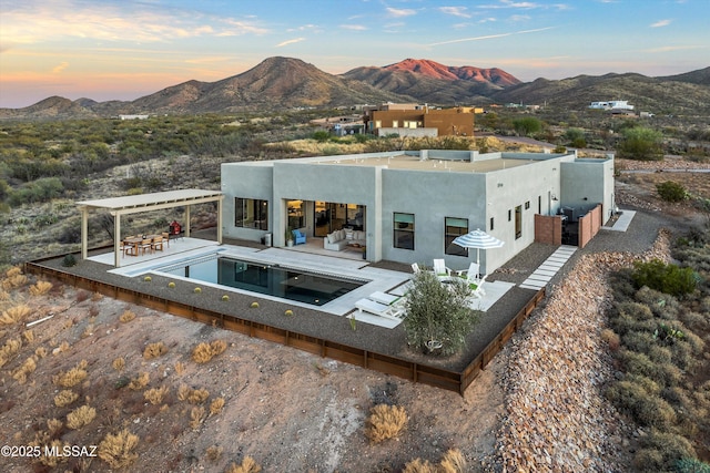 back house at dusk with a mountain view