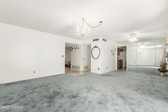 unfurnished living room with carpet, a textured ceiling, and ceiling fan with notable chandelier