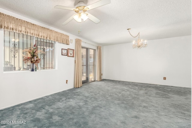 carpeted spare room featuring a textured ceiling and ceiling fan with notable chandelier