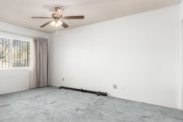 spare room with light carpet, a textured ceiling, and ceiling fan