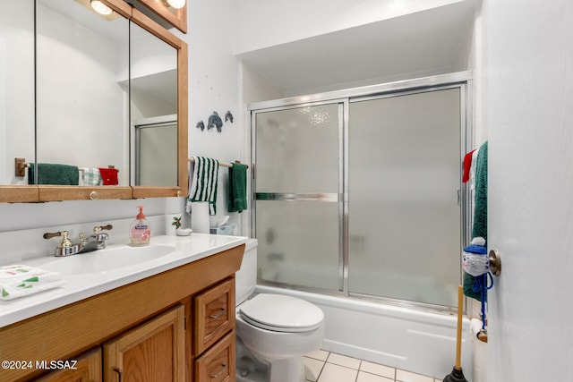 full bathroom with tile patterned floors, shower / bath combination with glass door, vanity, and toilet