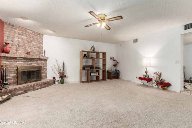 living room with carpet flooring, a fireplace, ceiling fan, and a textured ceiling