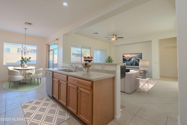 kitchen featuring sink, hanging light fixtures, a center island with sink, and light tile patterned floors