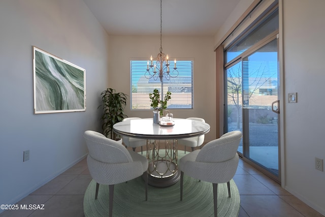 dining area with a chandelier and tile patterned flooring