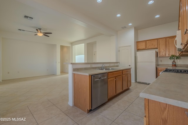 kitchen featuring sink, white refrigerator, stainless steel dishwasher, and an island with sink