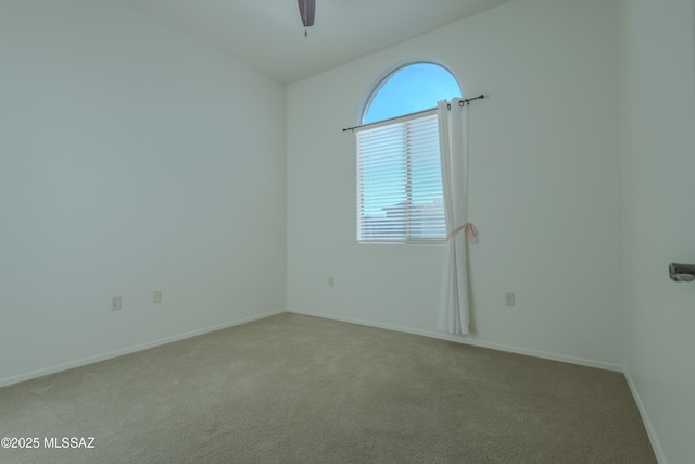 carpeted spare room with ceiling fan