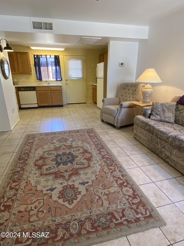 living room with light tile patterned flooring and sink