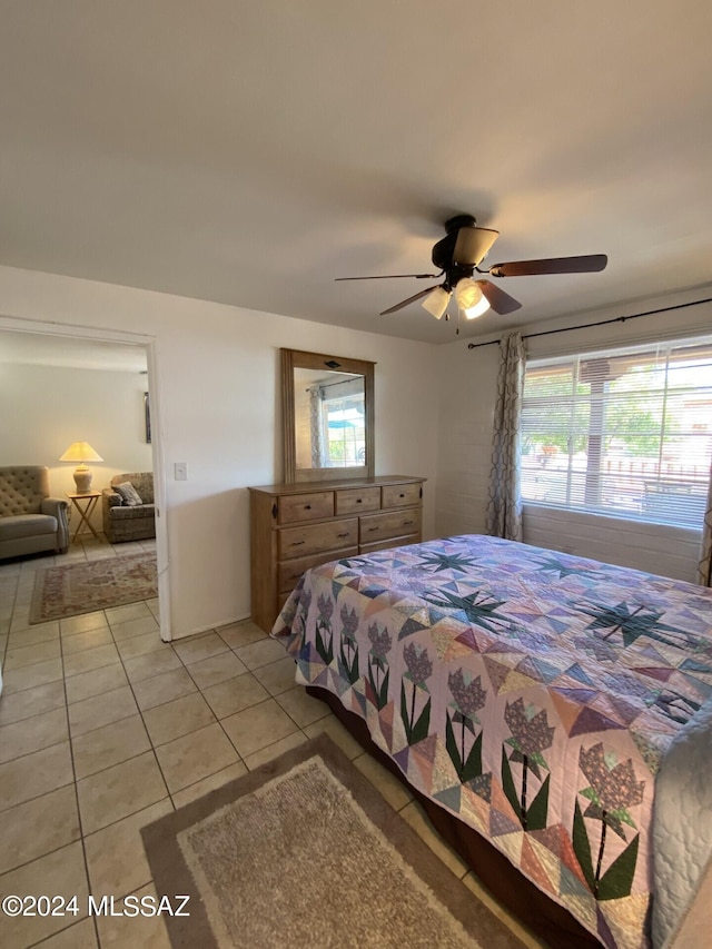 bedroom with ceiling fan and light tile patterned floors