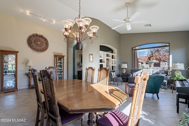 dining room featuring light tile patterned flooring, ceiling fan with notable chandelier, visible vents, and high vaulted ceiling