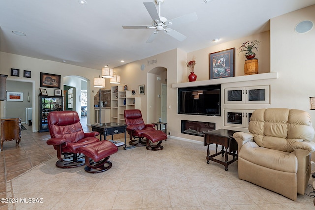 tiled living area featuring baseboards, visible vents, arched walkways, ceiling fan, and recessed lighting