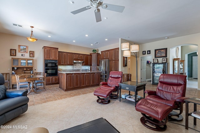 living room featuring visible vents, recessed lighting, a ceiling fan, arched walkways, and light tile patterned floors