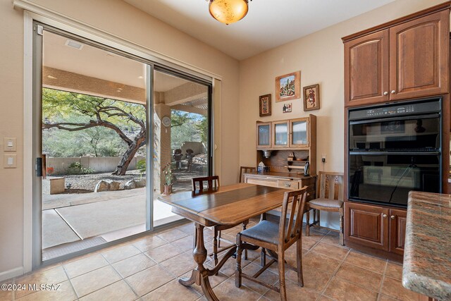 kitchen featuring tasteful backsplash, stainless steel fridge, and light stone countertops