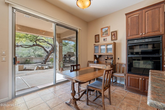 dining area with light tile patterned floors