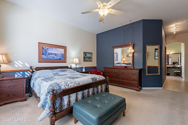 bedroom with arched walkways, vaulted ceiling, a ceiling fan, and light carpet