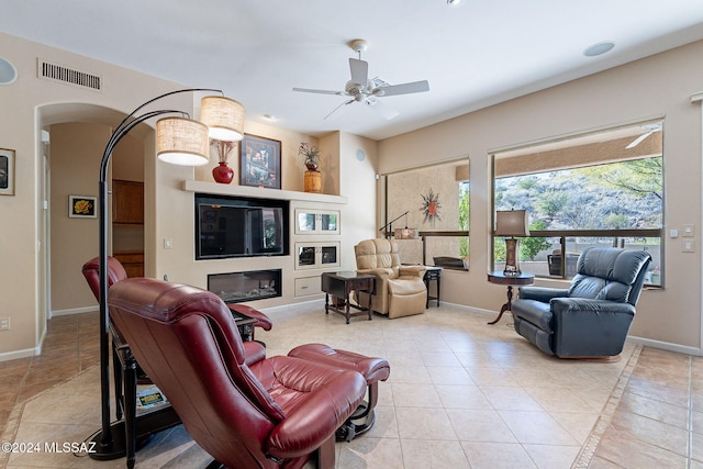 tiled living room with ceiling fan